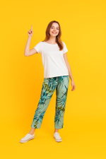 Green tropical leaf print trousers made from 100% plant-based viscose, designed in Bali